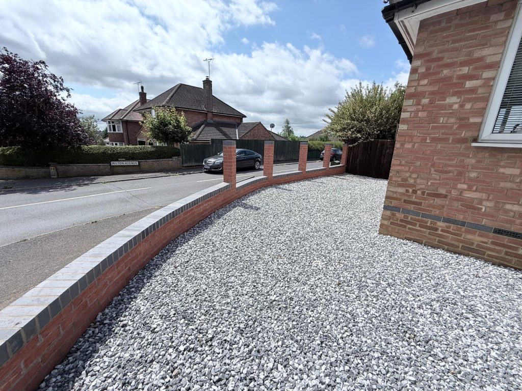 Wide view of decorative gravel side garden and curved brick retaining wall on Queensway Wellingborough