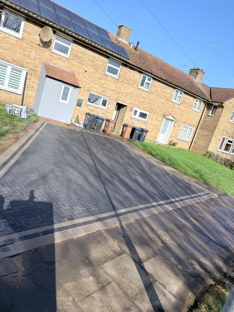 Completed 65m² charcoal block paving driveway featuring precision borders and herringbone layout on Windbrush Way, Northampton by AAS Group Construction