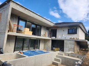 Exterior structure, reinforced concrete architecture, and glazing installation during a residential new build project by AAS Group Construction