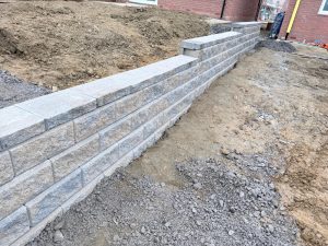 Stepped block retaining wall and hard landscaping groundworks at a residential new build in Overtone, Northampton by AAS Group Construction