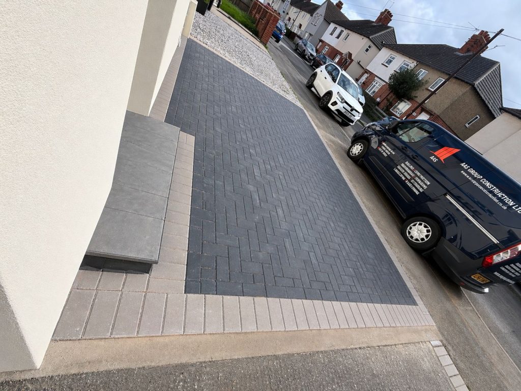 Completed charcoal Marshalls block paving driveway with a contrasting light border and matching doorstep in Rothwell Kettering