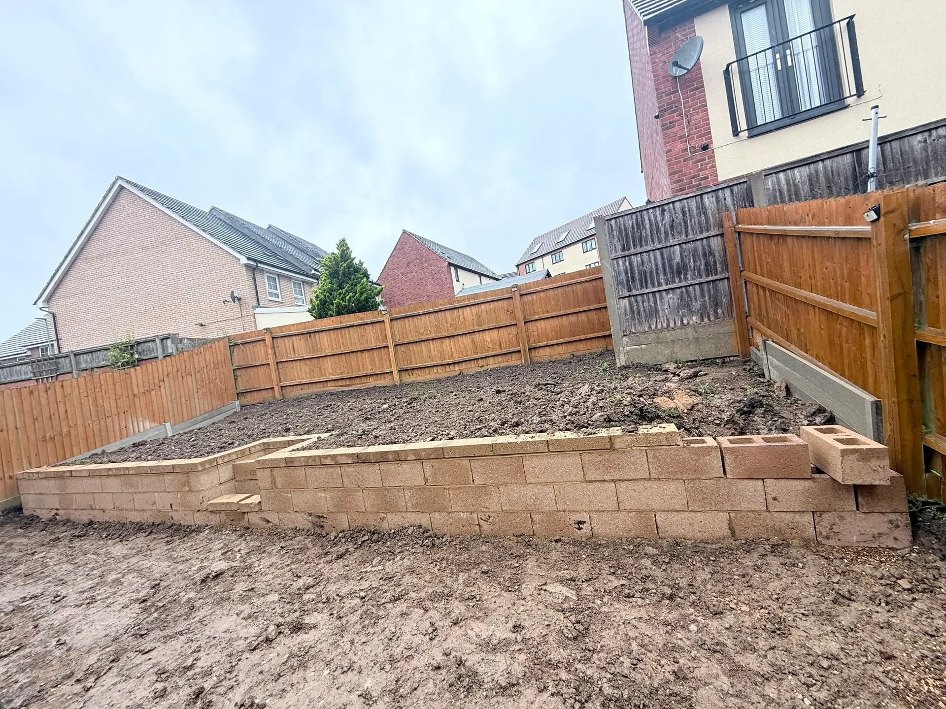 10m concrete block retaining wall under construction with steps in Wellingborough garden