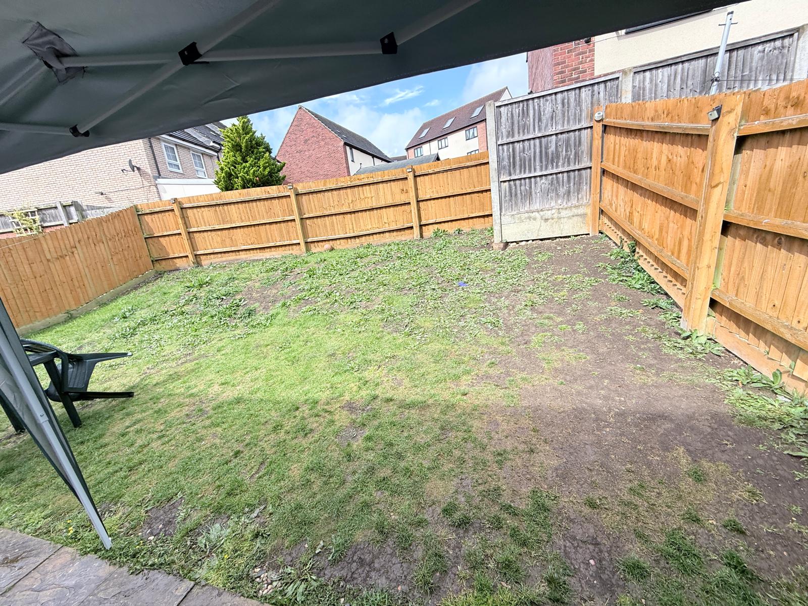 Sloping garden lawn before landscaping transformation in Talbot Road North Wellingborough
