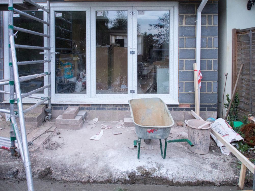 House renovation project showing scaffolding and construction tools on a UK building site.