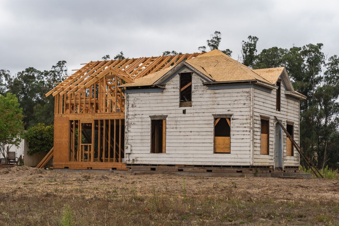 New home under construction showing a timber frame and groundworks in progress.