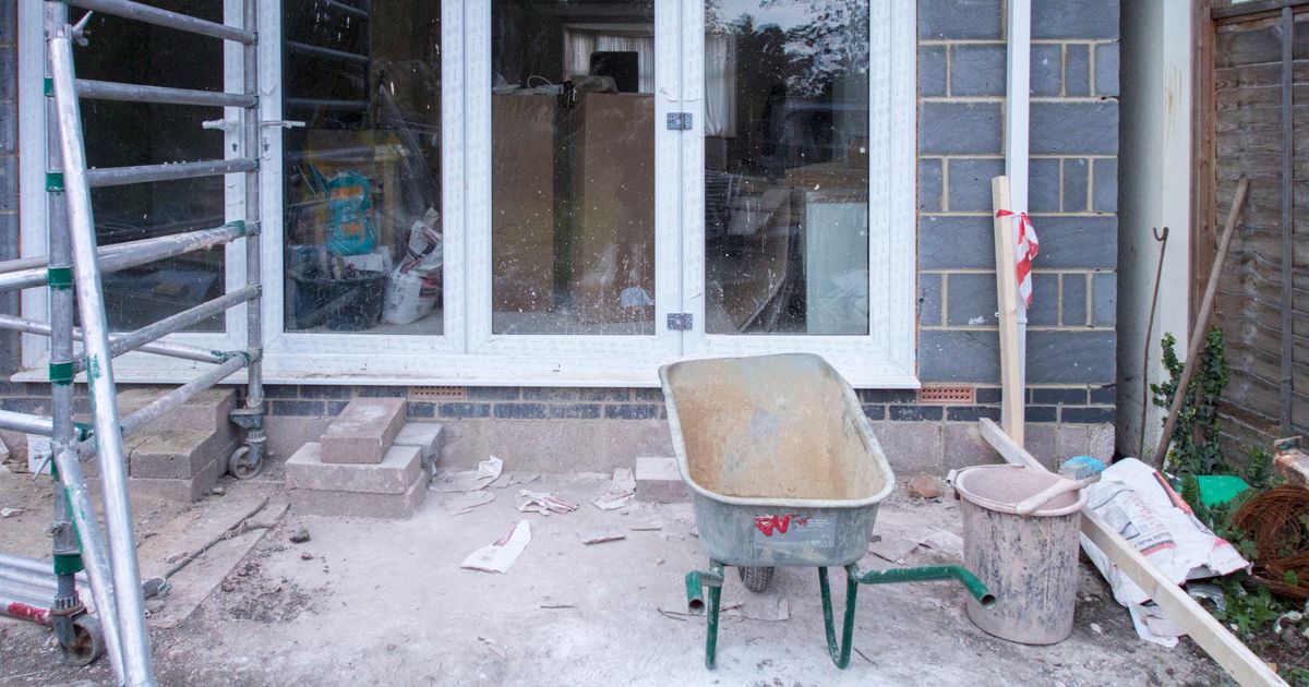 House renovation project showing scaffolding and construction tools during extension work